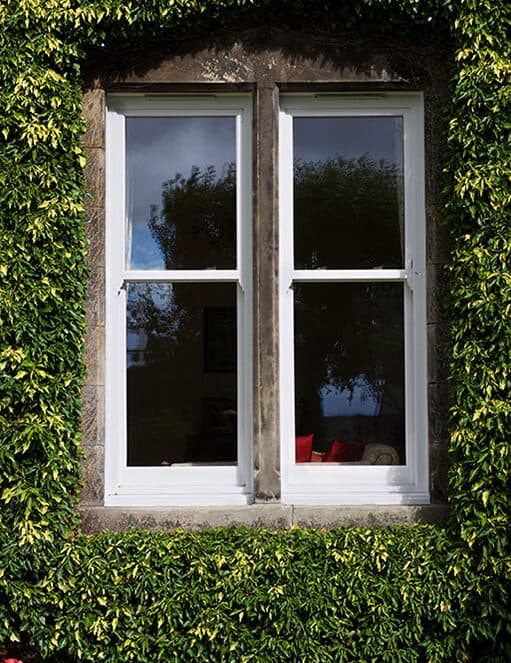 External view of two white sliding sash windows