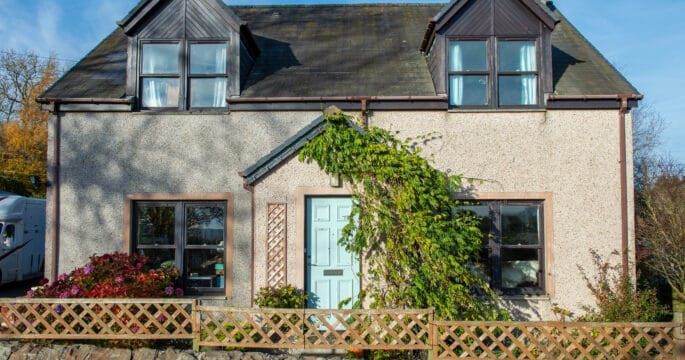 Before photo of a home with rotten timber windows