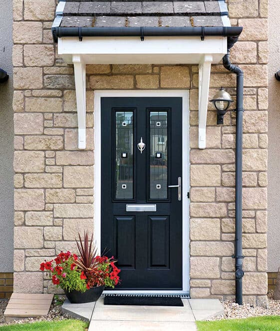 External view of home with black engineered timber front door with patterned glazing and urn knocker