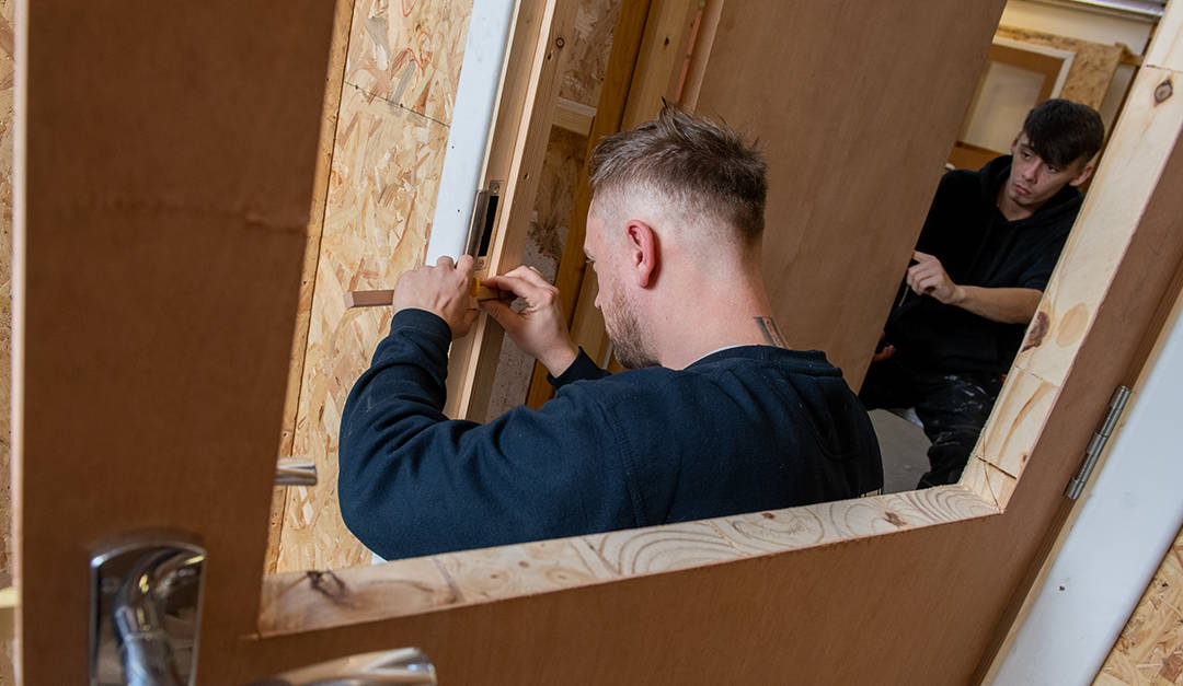 Close up photo of a CR Smith apprentice in the training workshop