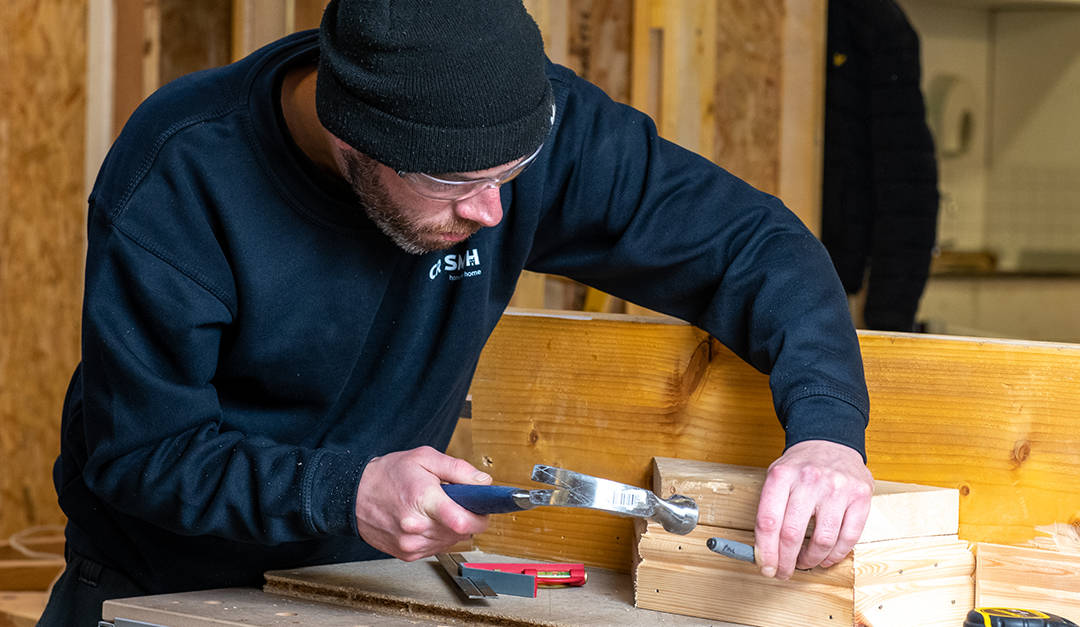 Close up photo of a CR Smith apprentice in the training workshop