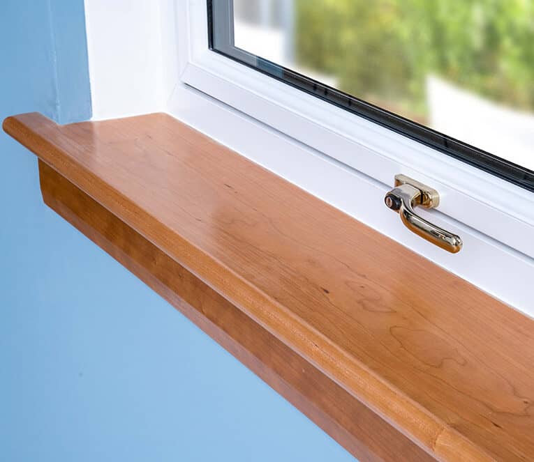 Close up of a cherry wood solid timber window sills
