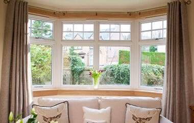 White casement bay window with royal oak sills and surrounds in a living room