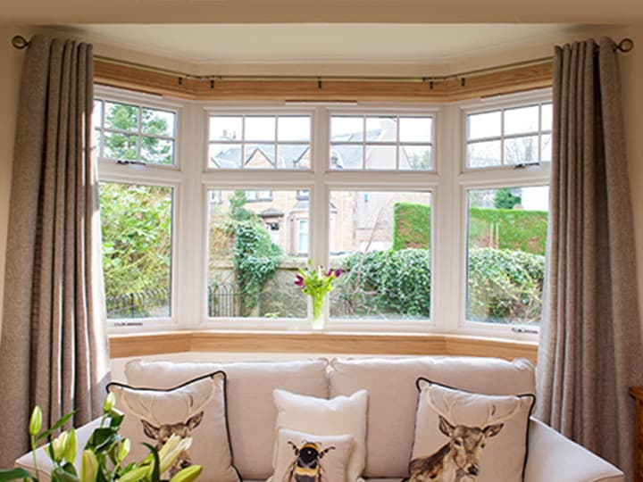 White casement bay window with royal oak sills and surrounds in a living room