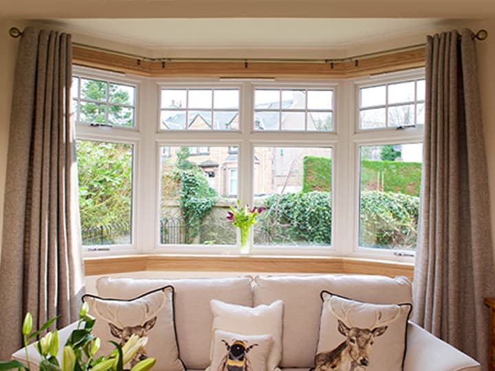 White casement bay window with royal oak sills and surrounds in a living room