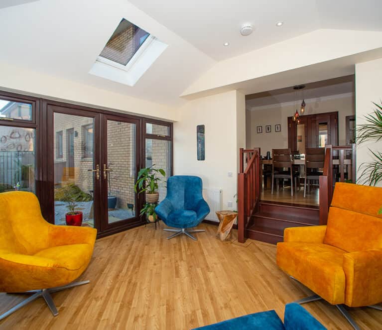 Internal view of open plan sunroom with steps leading to the dining rooms