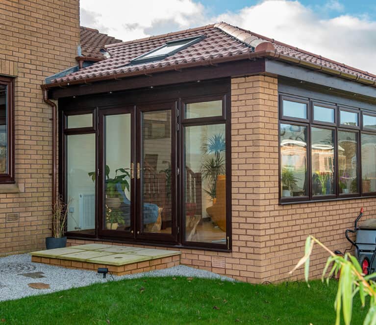 External view of lorimer sunroom with rosewood french doors and casement windows