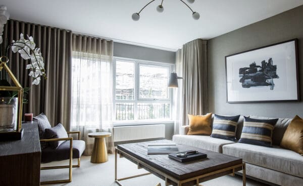 Living room with large windows and floor to ceiling curtains