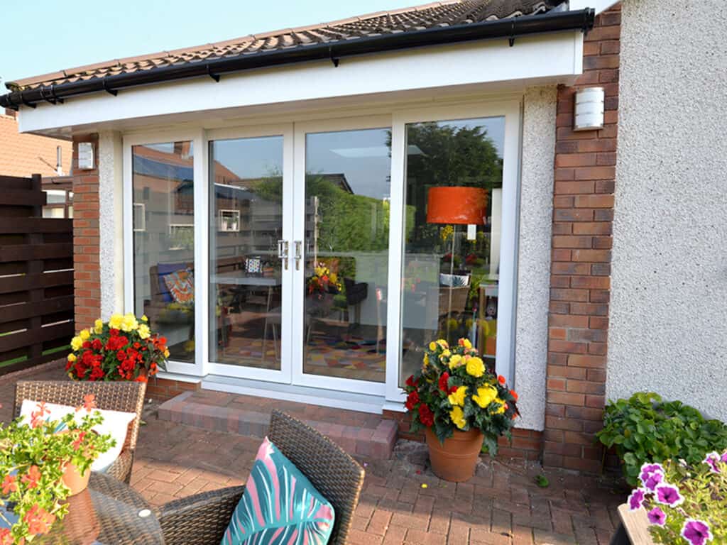 External view of white four part patio door