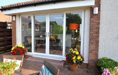 External view of white four part patio door