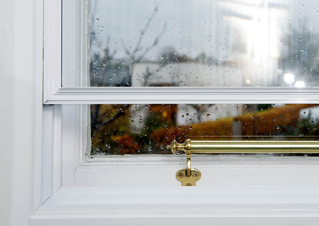 Close up of single glazed timber window fitted with secondary glazing