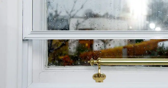 Close up of single glazed timber window fitted with secondary glazing