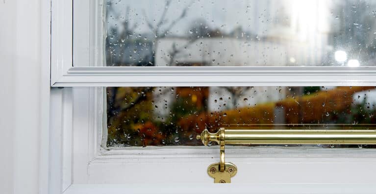 Close up of single glazed timber window fitted with secondary glazing