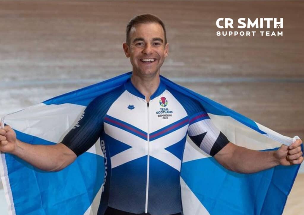 Photo of Kyle Gordon in his team Scotland commonwealth kit and Scotland flag