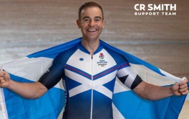 Photo of Kyle Gordon in his team Scotland commonwealth kit and Scotland flag