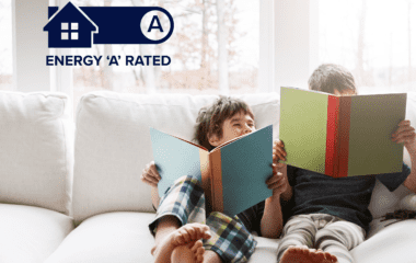 Two children sitting on the sofa reading books