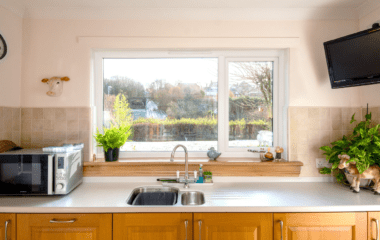 After photo of a white casement window with royal oak sills in a kitchen