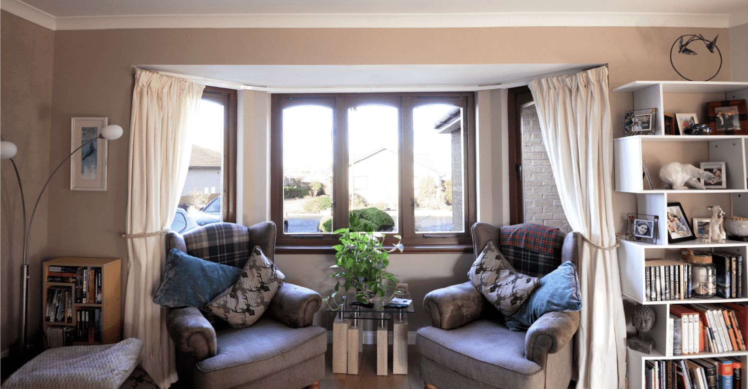 Before photo of a rosewood coloured bay window in a living room