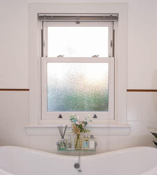 Bathroom with white sliding sash window with obscure glass and white sills and surrounds