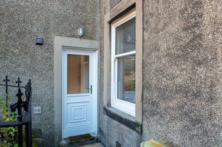 External view of white uPVC back door and white sliding sash window