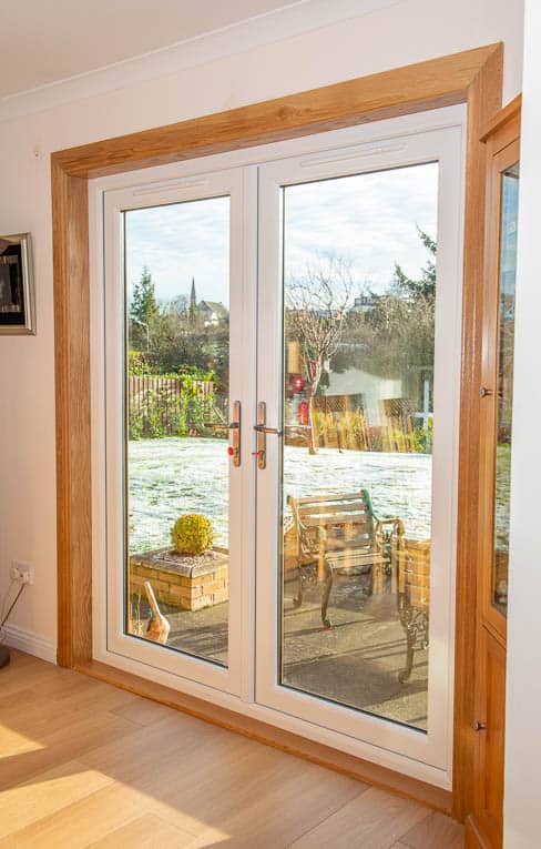 White french doors with royal oak timber surrounds