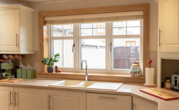 Internal view of white uPVC, double-glazed kitchen windows. Complete with Royal Oak sill and surroundings.