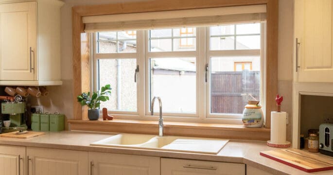 Kitchen with white casement windows with royal oak sills and surrounds