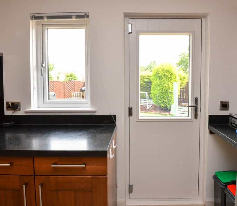 White casement kitchen window and back door