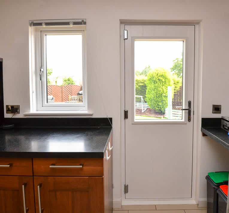 White casement kitchen window and back door