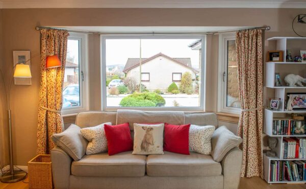 Living room with three part bay window. Casement windows with royal oak sills.