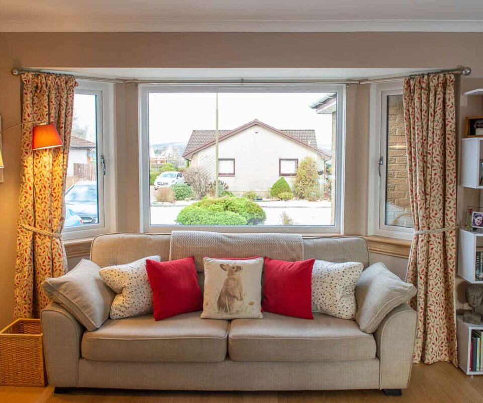 Living room with three part bay window. Casement windows with royal oak sills.