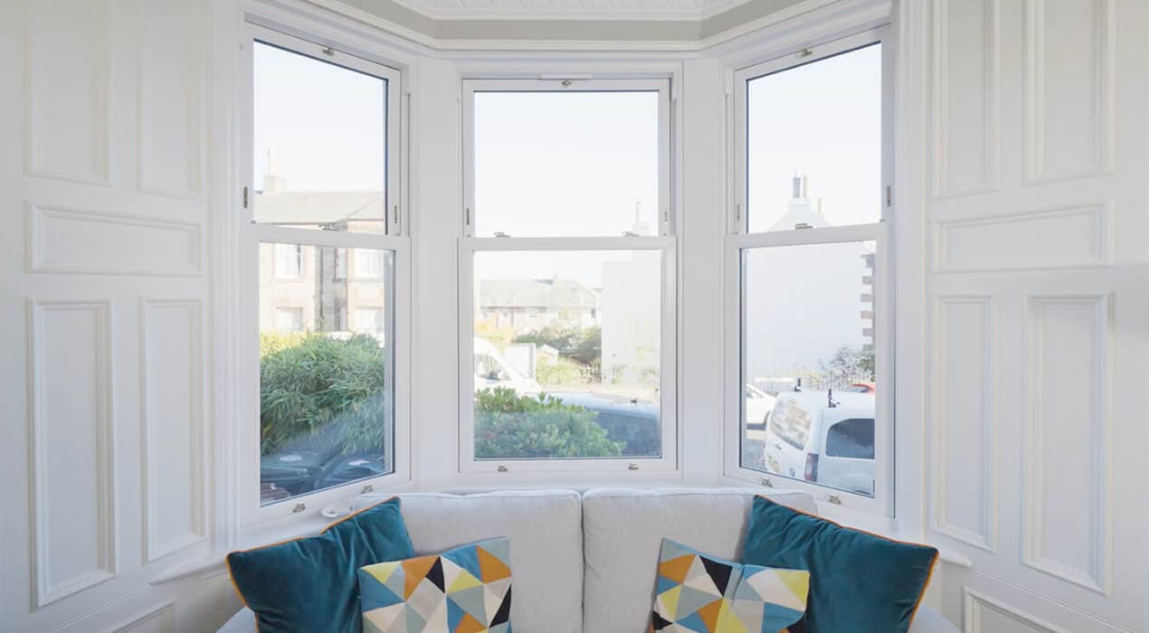 Living room bay window with white upvc sliding sash windows