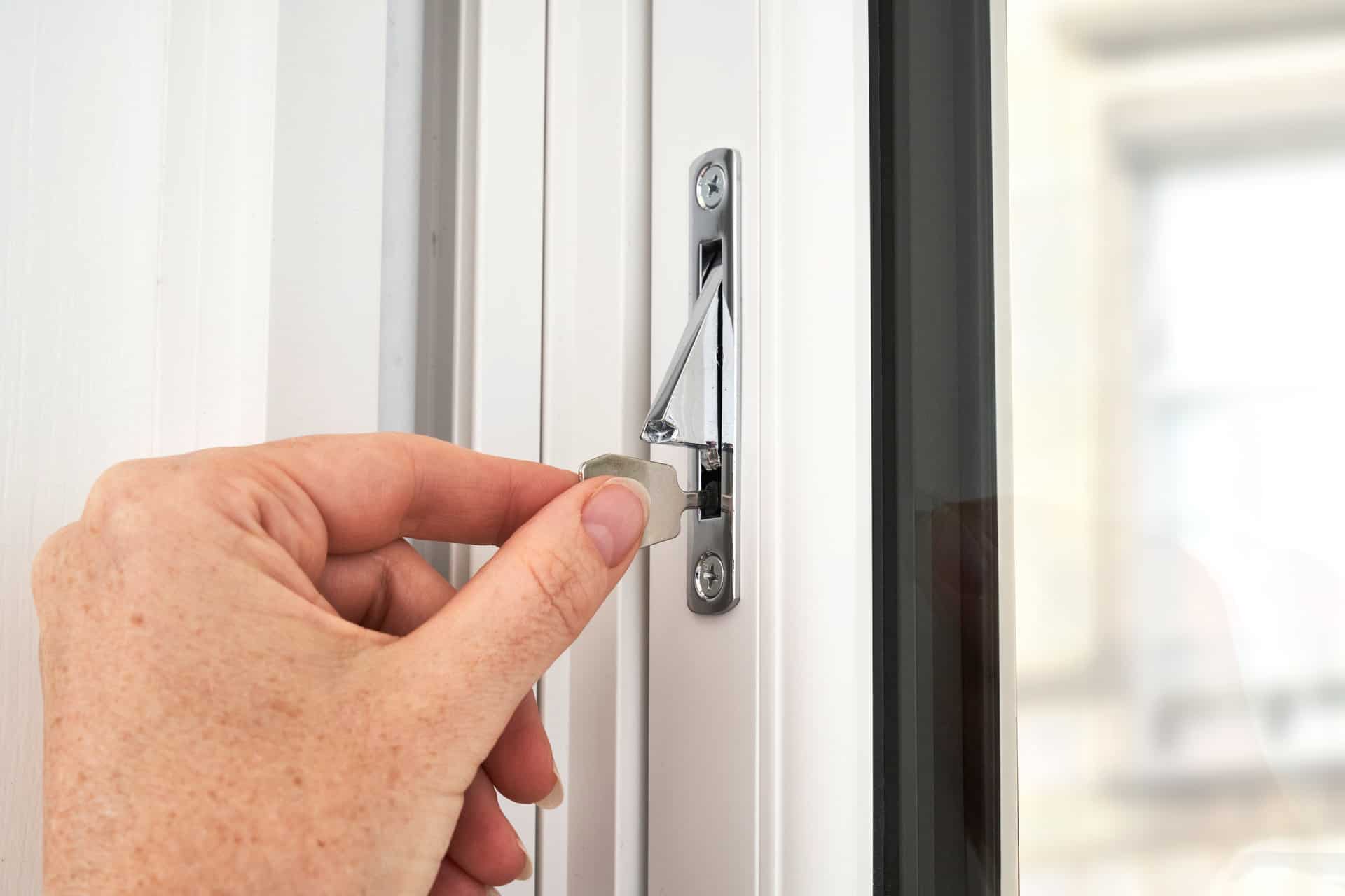 Close up demonstration of the key required to deactivate the sliding sash travel restrictor