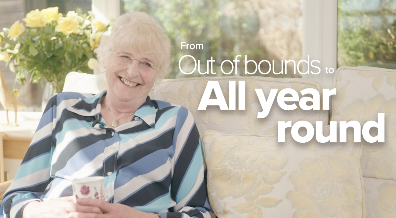 Author Morag Ridings sitting on her sofa in her conservatory