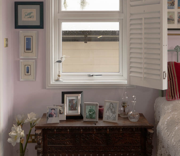 Internal view of white casement window with white shutters open