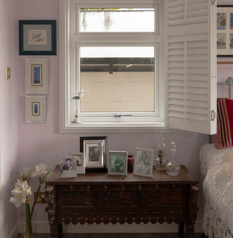 Internal view of white casement window with white shutters open