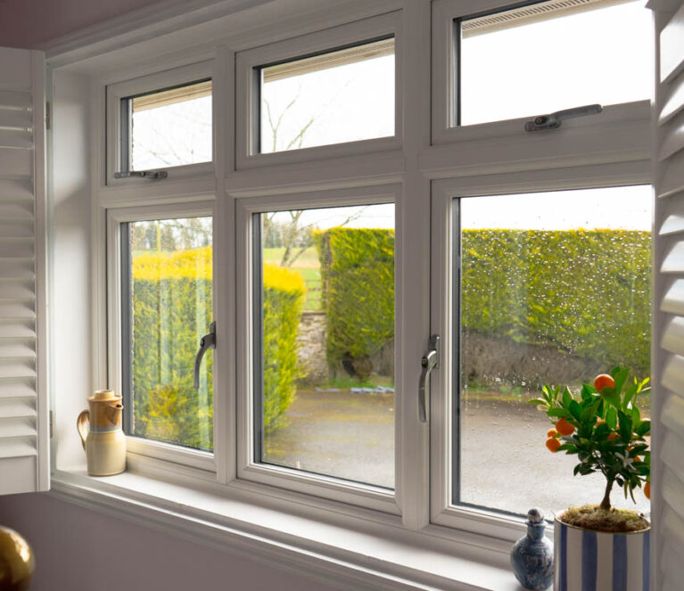 Internal view of white casement windows with shutters open