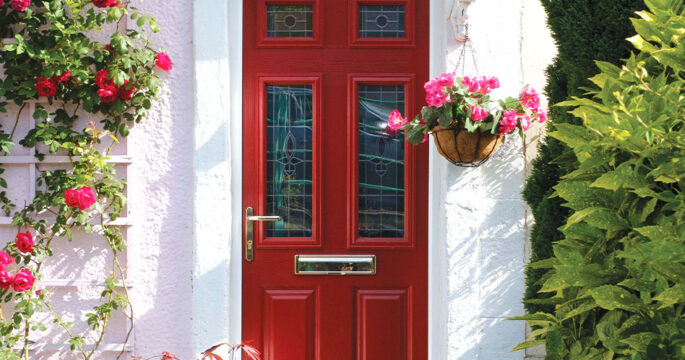 Cherry red front door, complete with lever handle, decorative glass inserts and stainless steel letterbox. From our timberLuxe range of composite doors.