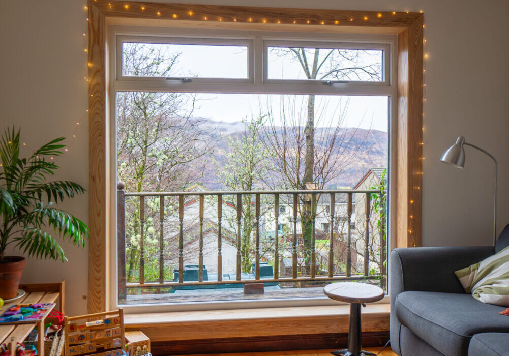 A white uPVC casement window with top hoppers, complete with royal oak timber sills and surrounds at a Fort William Installation.