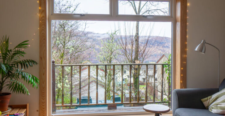 A white uPVC casement window with top hoppers, complete with royal oak timber sills and surrounds at a Fort William Installation.
