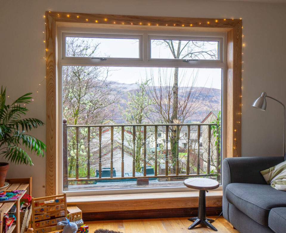 A white uPVC casement window with top hoppers, complete with royal oak timber sills and surrounds at a Fort William Installation.