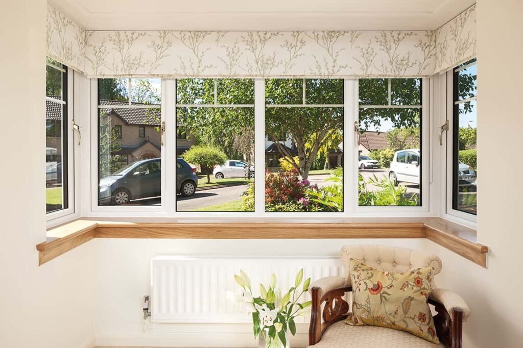 Internal image of a Lorimer casement window in white finish, with Georgian bars. Complete with a royal oak timber sill.