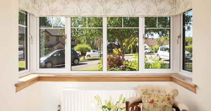 Internal image of a Lorimer casement window in white finish, with Georgian bars. Complete with a royal oak timber sill.