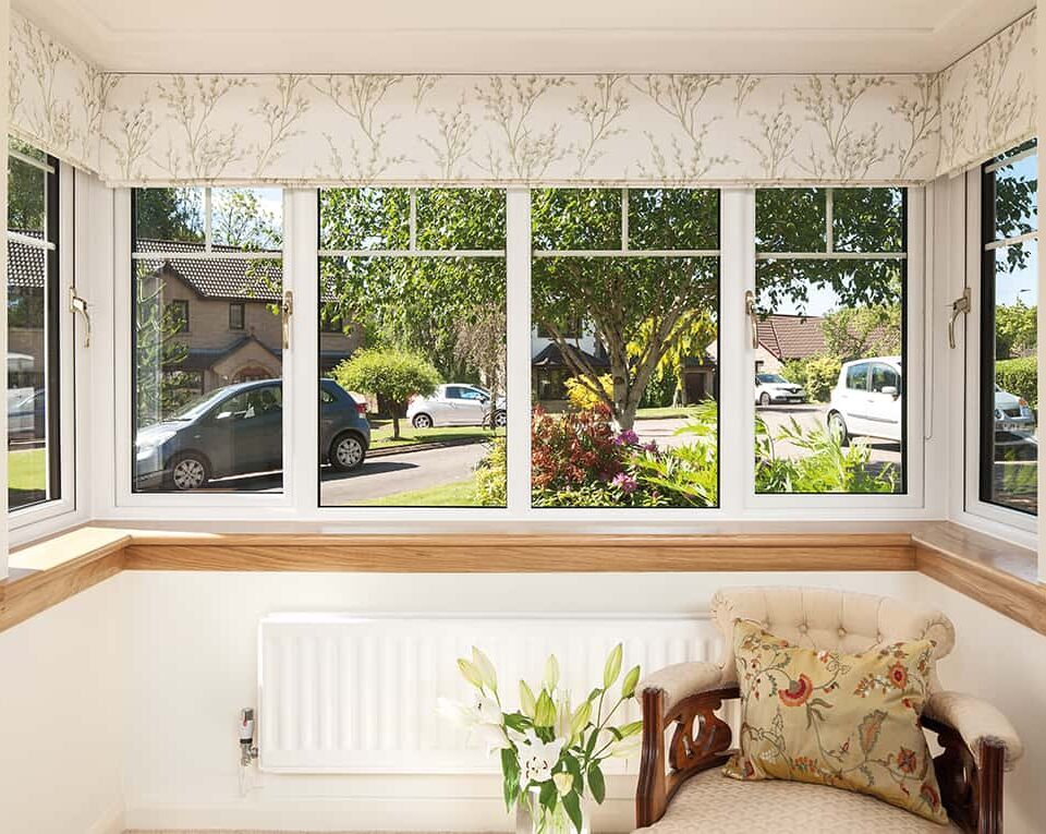 Internal image of a Lorimer casement window in white finish, with Georgian bars. Complete with a royal oak timber sill.