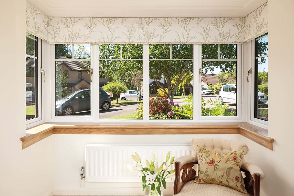 Internal image of a Lorimer casement window in white finish, with Georgian bars. Complete with a royal oak timber sill.