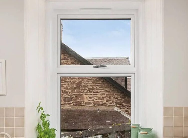 White Lorimer Casement window located abover the sink in the kitchen, with fixed bottom pane and top opener. Complete with internal white sills and surround.