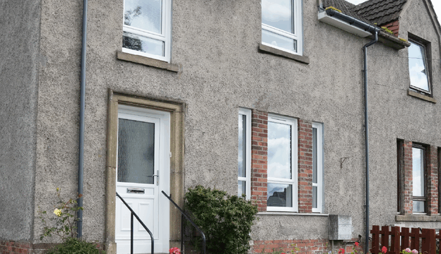 Full house exterior shot with new white Lorimer casement window and white uPVC front door.