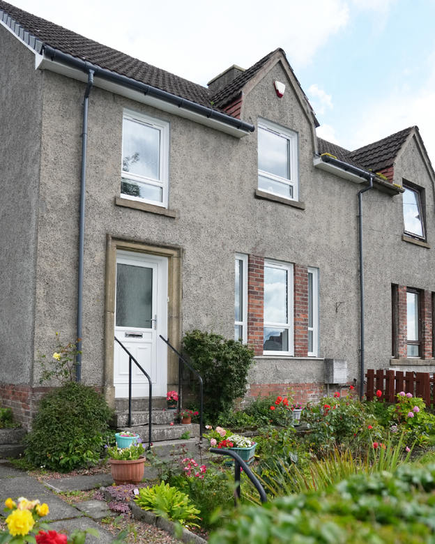 Full house exterior shot with new white Lorimer casement window and white uPVC front door.