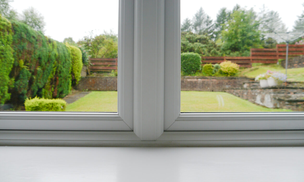 Internal image of white casement windows. Close up of mechanical join.