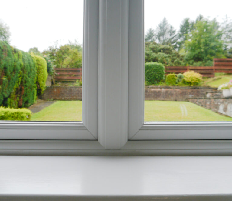 Internal image of white casement windows. Close up of mechanical join.